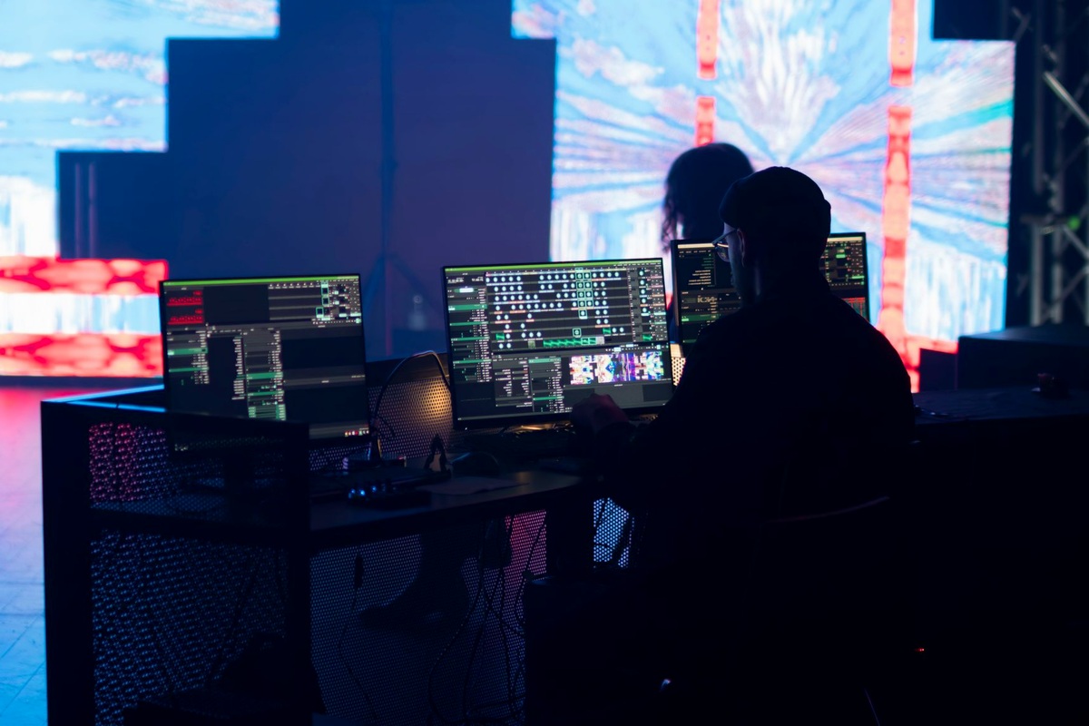 Dark event room with projection walls and cool coloured lighting at a cyberpunk night